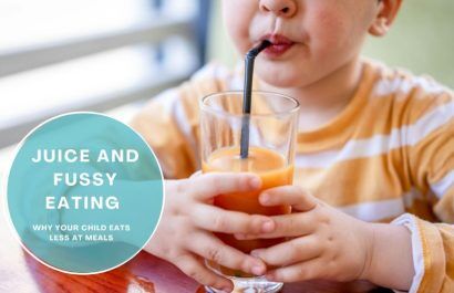 Child drinking fruit juice at the table instead of eating a meal
